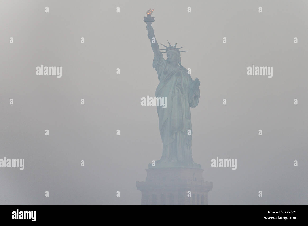 Statue Of Liberty National Monument in a foggy weather, New York City