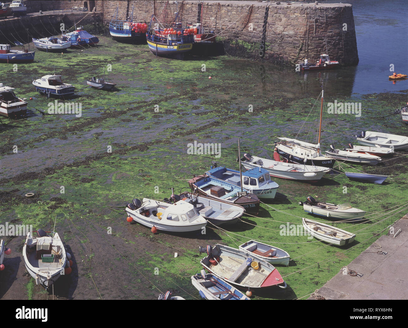 Channel Islands. Alderney.  Braye Harbour. The inner harbour at low tide. Stock Photo