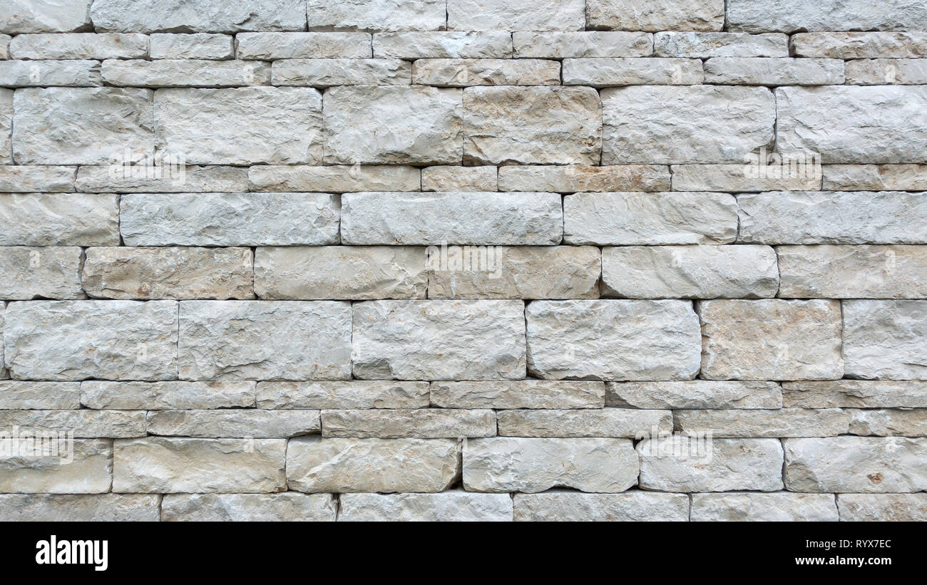 Gray dry stone wall of coarse natural stones Stock Photo