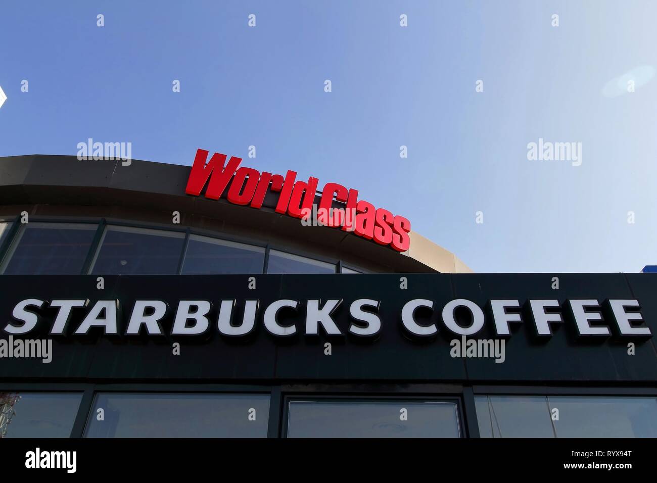 Bucharest, Romania - October 17, 2018: The signs of World Class fitness and Starbucks Coffee are present on a mall in Bucharest, Romania. This image i Stock Photo