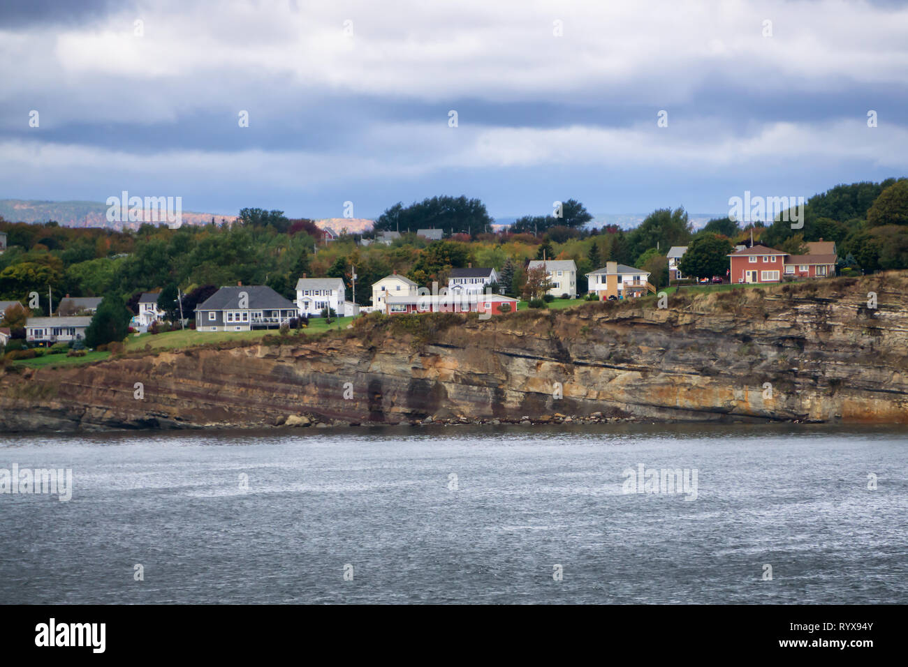 Residential homes on a rocky coast during a cloudy day. Taken in North
