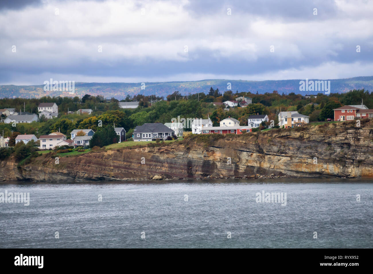 Residential homes on a rocky coast during a cloudy day. Taken in North