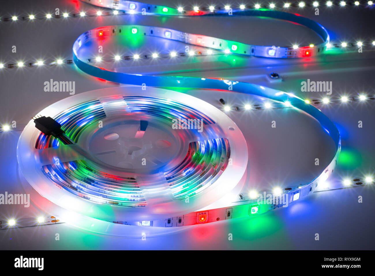 Bright RGB LED stripnon table with white strips electronics energy saving decoration technology background Stock Photo