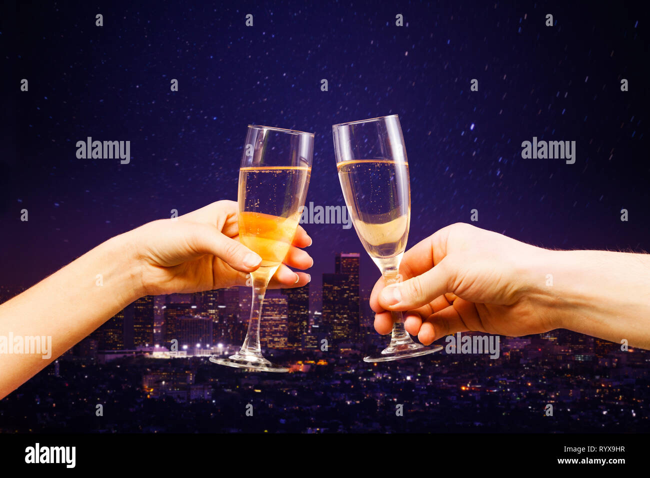 Los Angeles at night panorama with two glasses of champagne sparkling