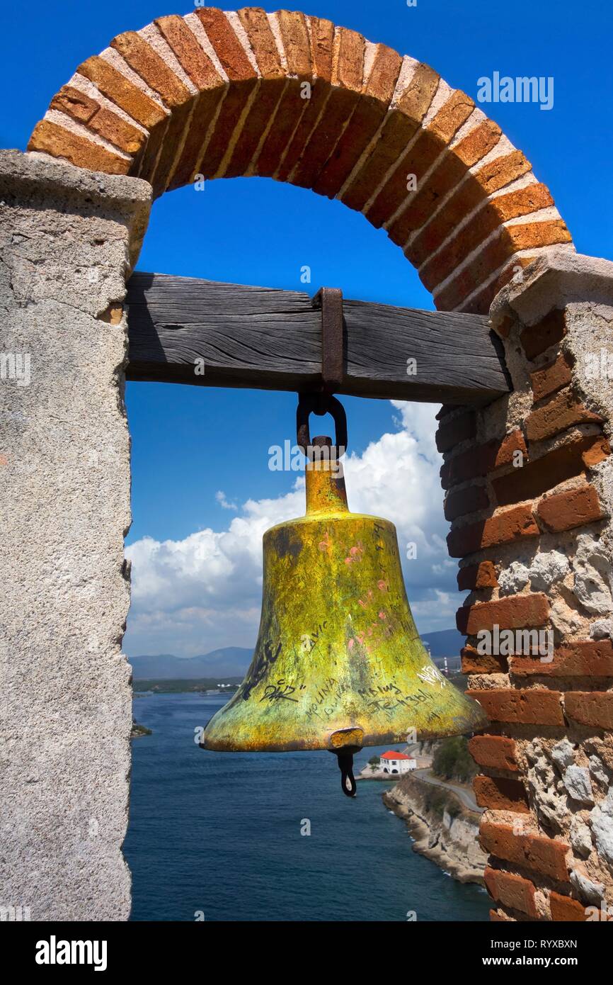 Warning Bell in Historic San Pedro de la Roca Medieval Fort overlooking Santiago de Cuba Bay Stock Photo