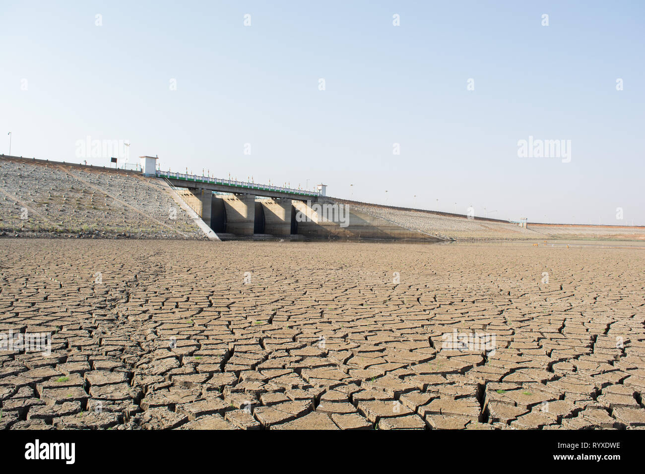 A dried up empty reservoir or dam during a summer heatwave, low rainfall and drought in north karnataka,India Stock Photo