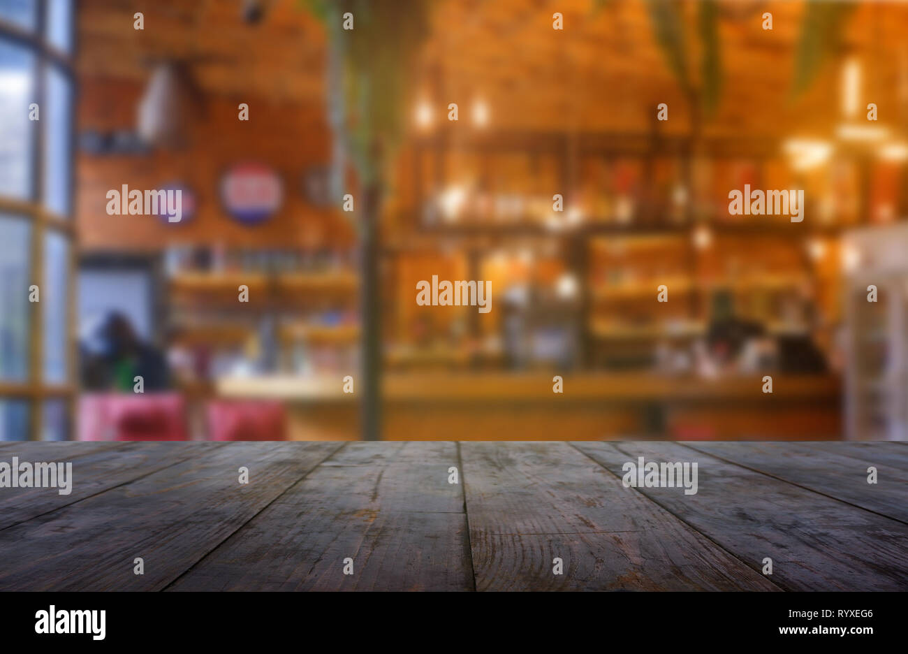 Empty wooden table in front of abstract blurred background of ...