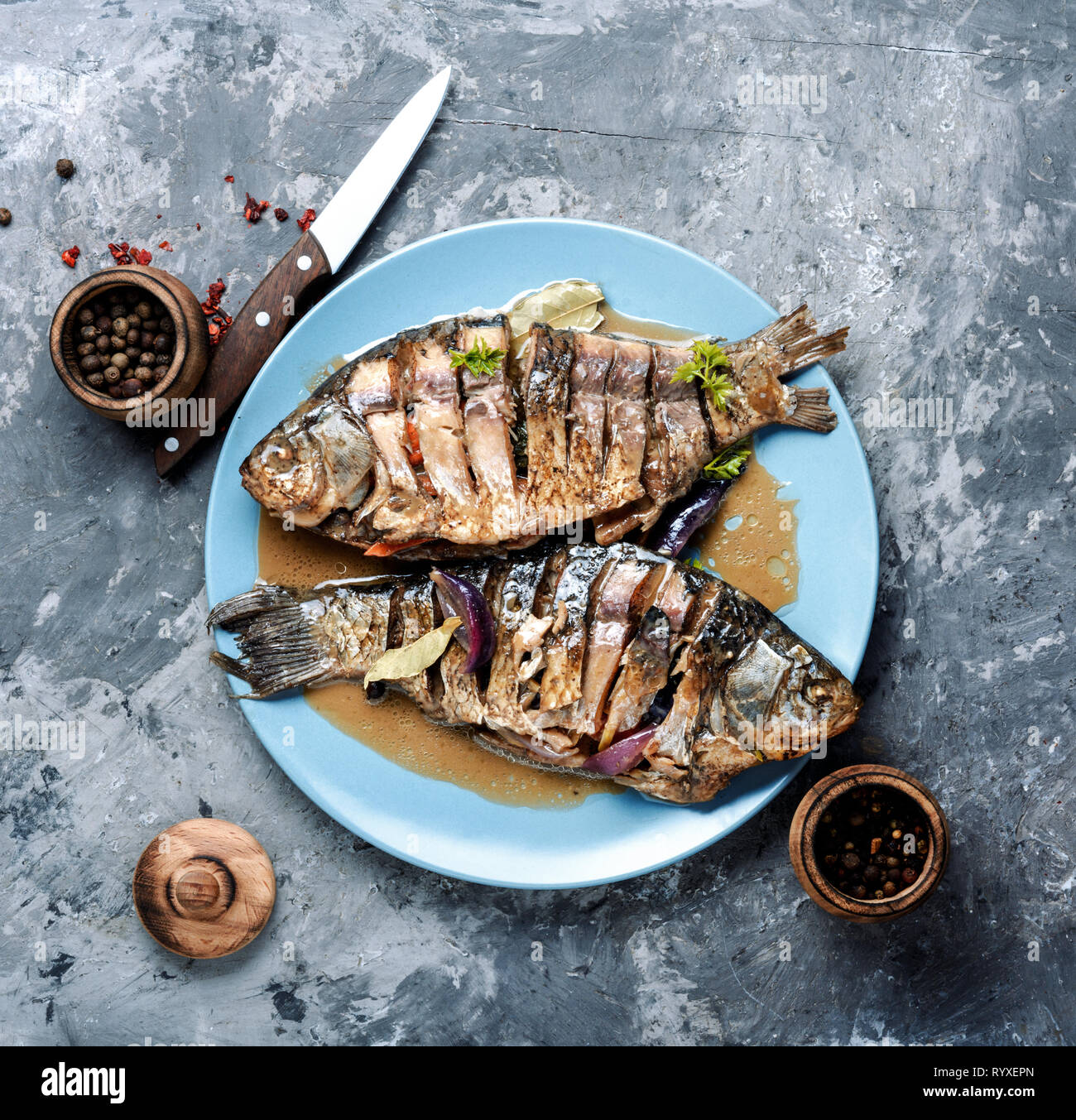 Grilled whole fish with citrus, and vegetable on rustic table Stock ...