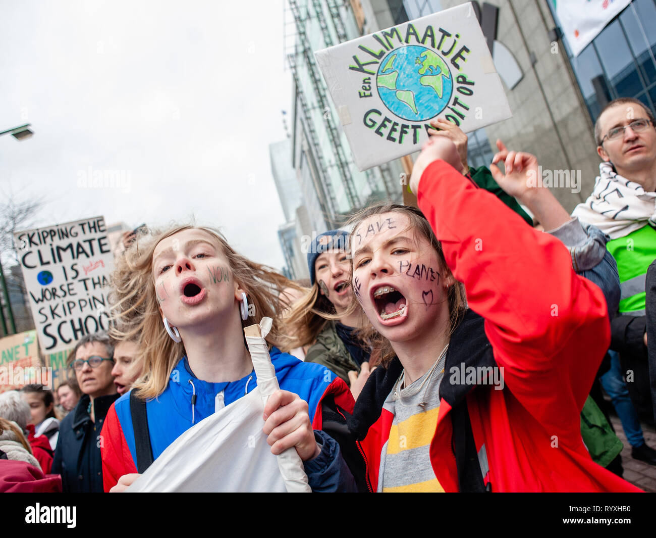Brussels, North Brabant, Belgium. 15th Mar, 2019. People are seen screaming slogans behind the principal banner during the Global climate strike for future rally. This Friday, tens of thousands of kids in more of 60 countries went on strike to demand climate change action. The school strike movement was inspired by Swedish teenager Greta Thunberg, who has been striking from school every Friday since last August to stand outside the Swedish parliament building and demand that her home country adheres to the Paris agreement on climate change. In Brussels, not just students, but teachers, scien Stock Photo