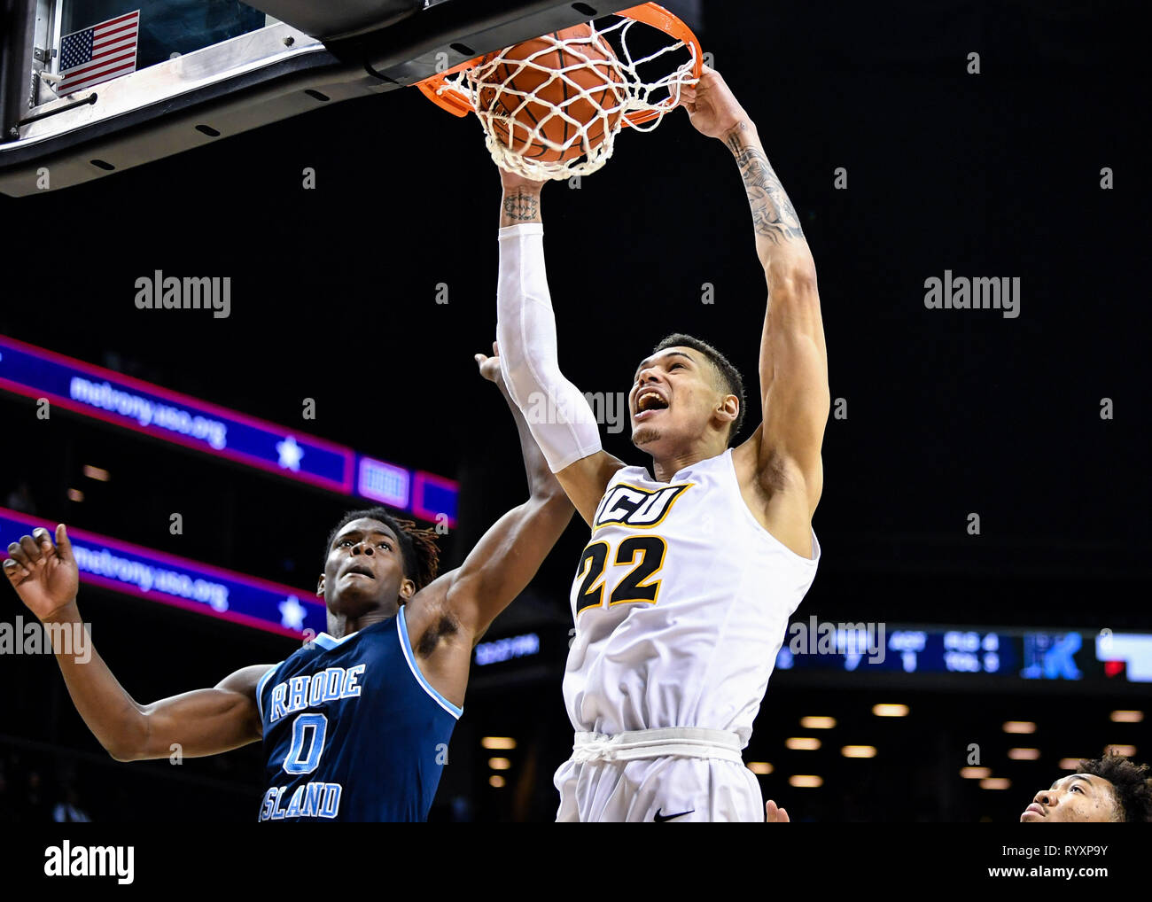 Brooklyn, New York, USA. 15th Mar, 2019. Virginia Commonwealth Rams forward MICHAEL GILMORE (22) goes to the basket for a slam dunk over Rhode Island Rams forward JERMAINE HARRIS (0) during the first half at Barclays Center Credit: Terrence Williams/ZUMA Wire/Alamy Live News Stock Photo