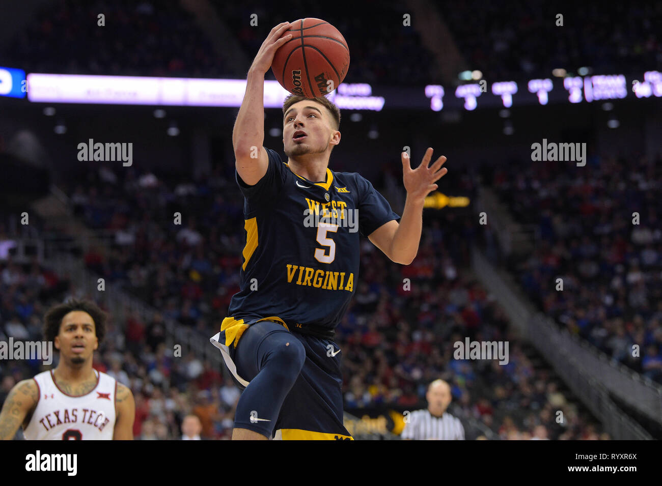 Kansas City, Missouri, USA. 14th Mar, 2019. West Virginia Mountaineers guard Jordan McCabe (5) drives to the basket during the 2019 Phillips 66 Big 12 Men's Basketball Championship Quarterfinal game between the Texas Tech Red Raiders and the West Virginia Mountaineers at the Sprint Center in Kansas City, Missouri. Kendall Shaw/CSM/Alamy Live News Stock Photo