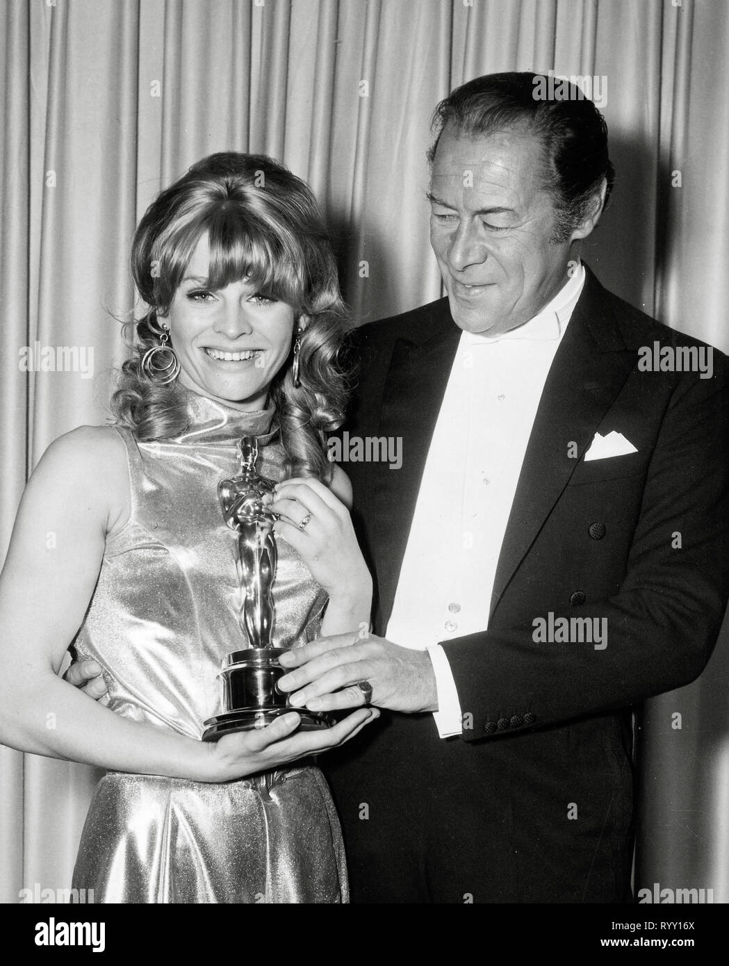 Julie Christie, receiving her Best Actress Oscar for "Darling" from Rex  Harrison at the 38th Annual Academy Awards, 1966 File Reference # 33751  832THA Stock Photo - Alamy