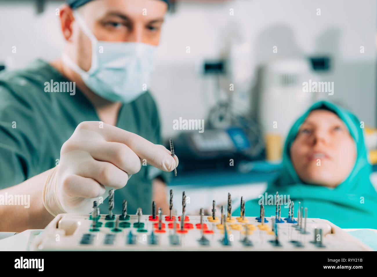 Dentist installing dental implant. Stock Photo