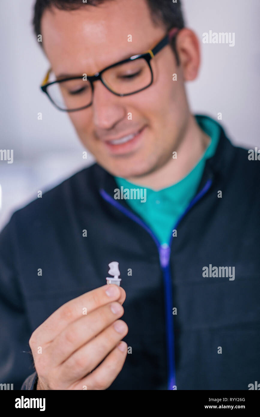 Dental technician holding prosthetic Stock Photo Alamy