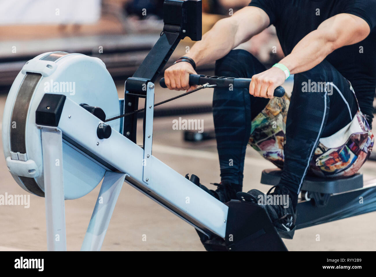 Rowing machine workout. Stock Photo