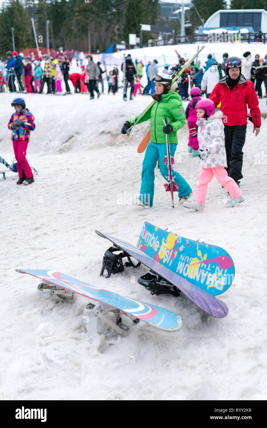Szklarska Poreba, Poland - February 2019 : Colorful snowboards left in the snow on the mountain slope in winter Stock Photo