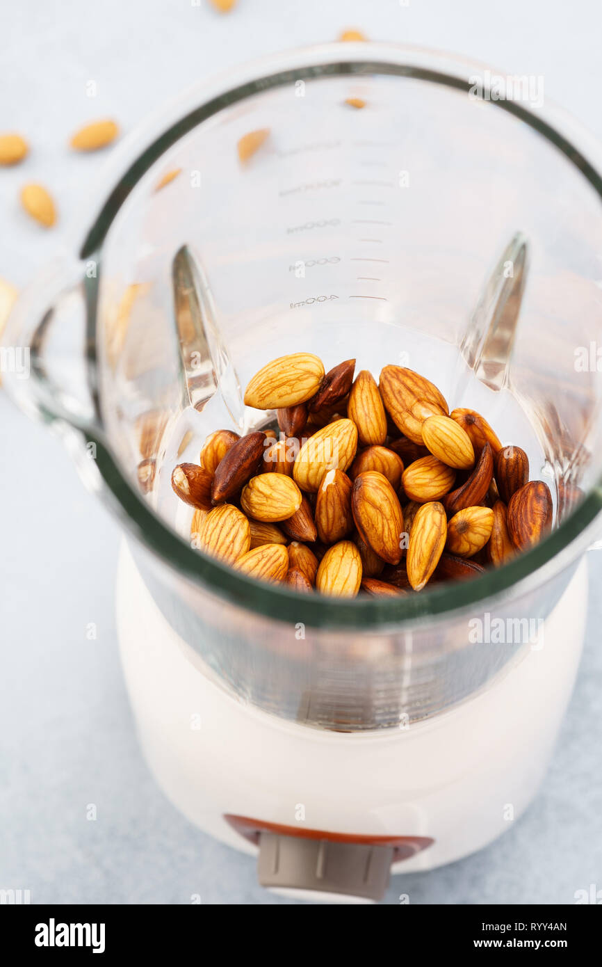 Blender with soaked almonds for making nut milk