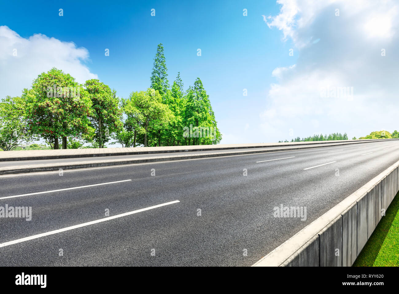 Asphalt road and green woods in the countryside nature park Stock Photo ...