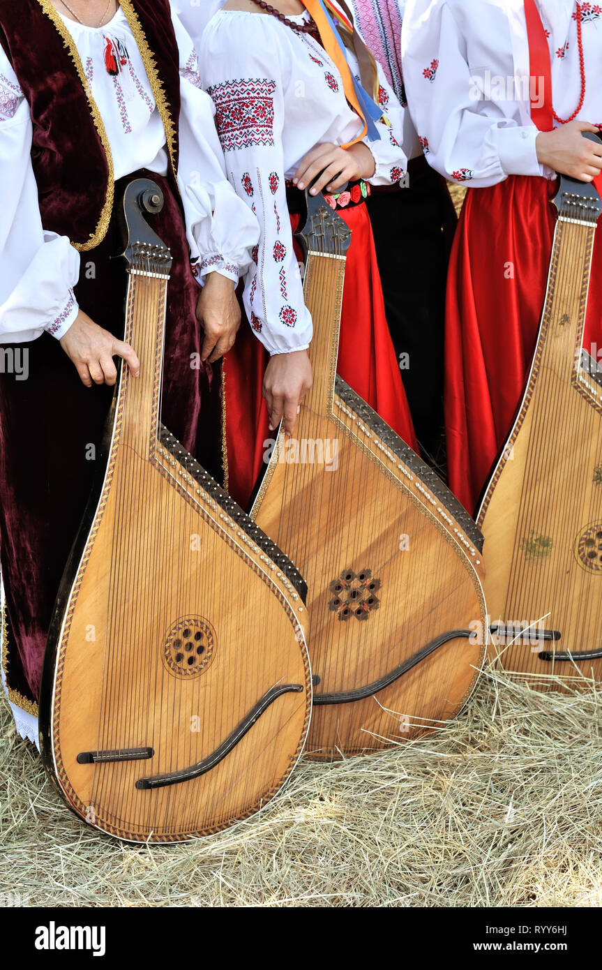 Unrecognizable ethnic musicians  with  ukrainian  instruments bandura (pandora)  in the folk festival Stock Photo