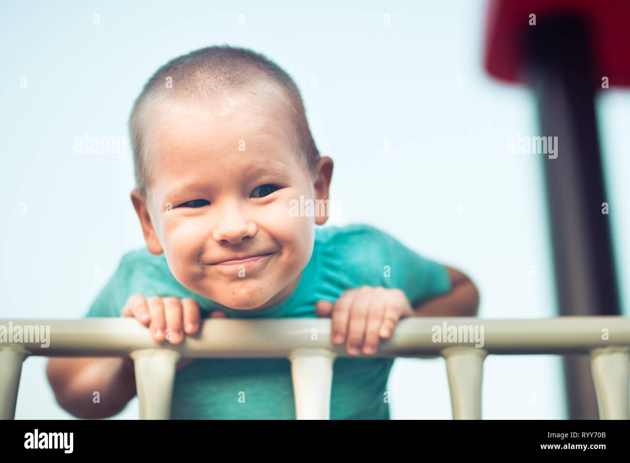 Little smiling boy playing on a slide. Outdoor activity Stock Photo Alamy