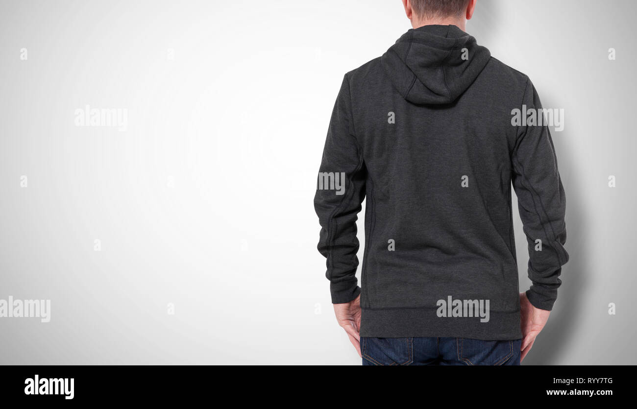 Man in black sweatshirt, black hoodies rear view isolated on grey background. mock up Stock Photo