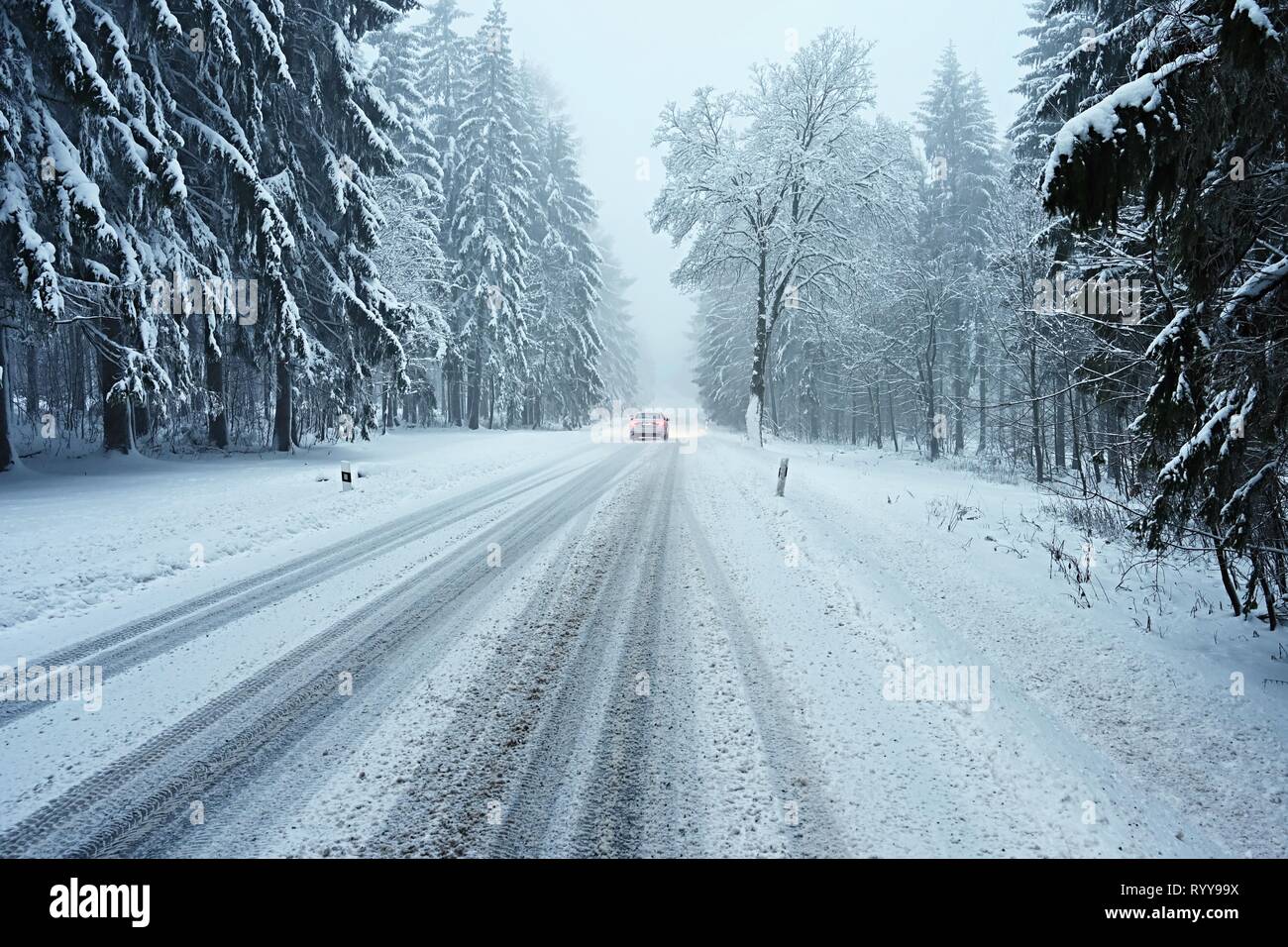 Snowy winter road with car. Dangerous car driving in the mountains in ...
