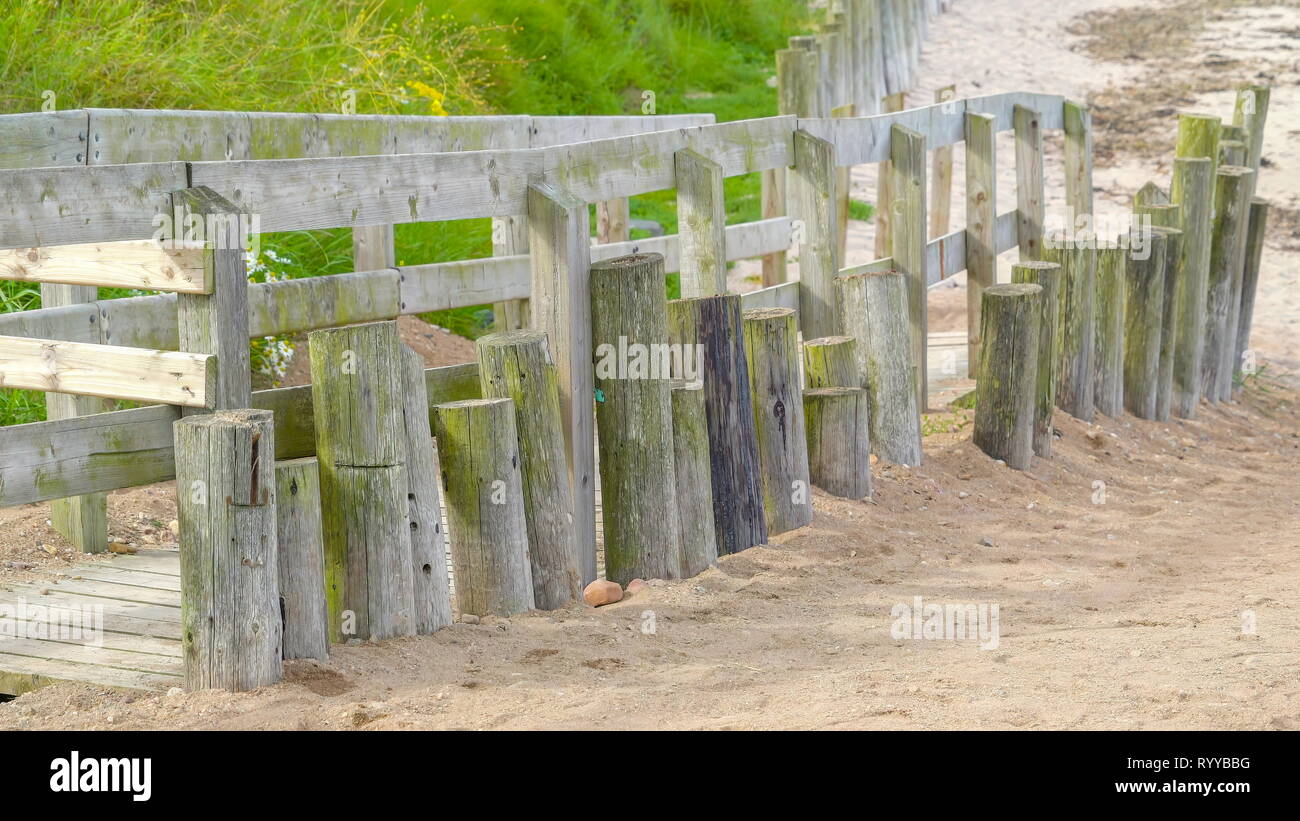 White wooden fence with green lawns on the mountain side in the Northern side of Ireland Stock