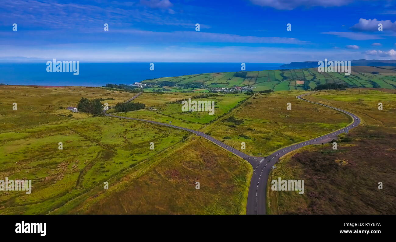 Aerial shot of the two intersecting road in the valley these roads are going to the small village of Cushendun in North Ireland Stock Photo