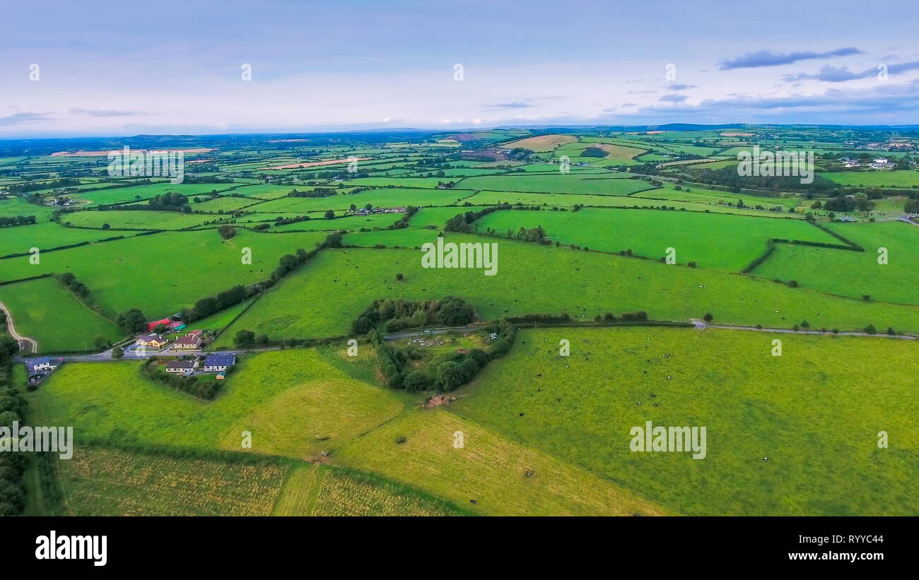 The green fields on the town in Ireland taken in an aerial view with