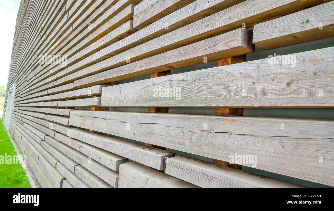 A big house with the wall made in wood planks lots of wooden planks to make the modern wall of the house in Ireland Stock Photo