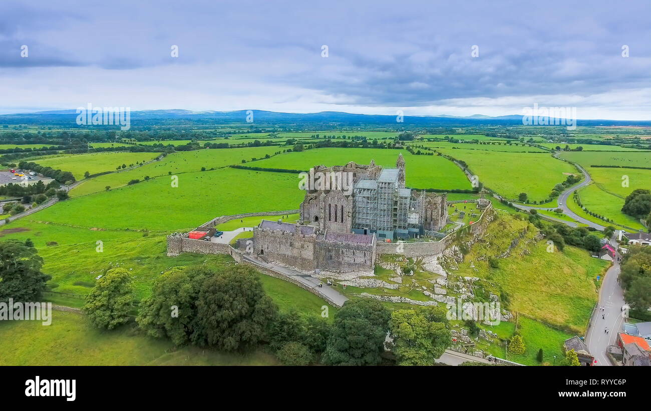 The aerial view of the Rock of Cashel and the green fields on the back of the old ruined castle in Ireland Stock Photo