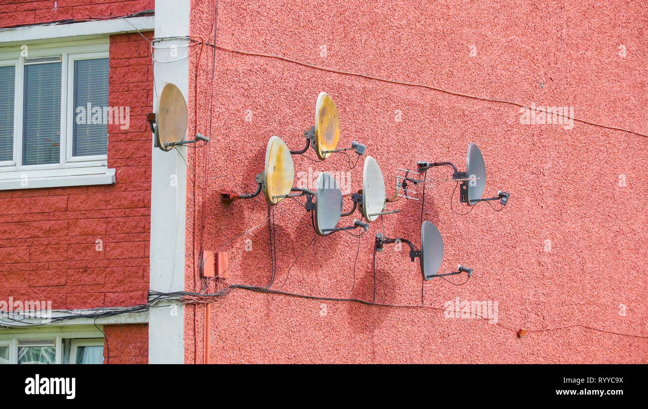 Satellite dishes on the wall of the building used in communication and television signal Stock Photo