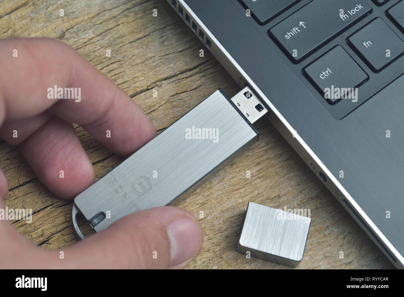 Galati, Romania - March 15, 2019: Close up of Kingston Ironkey ultra secure USB flash drive connected to laptop on wood desk Stock Photo