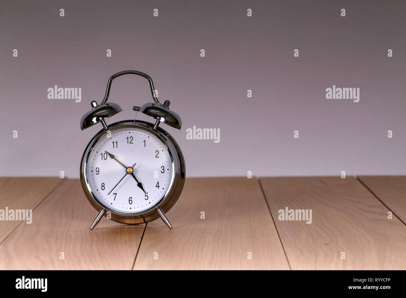 The old alarm clock on a light background Stock Photo - Alamy