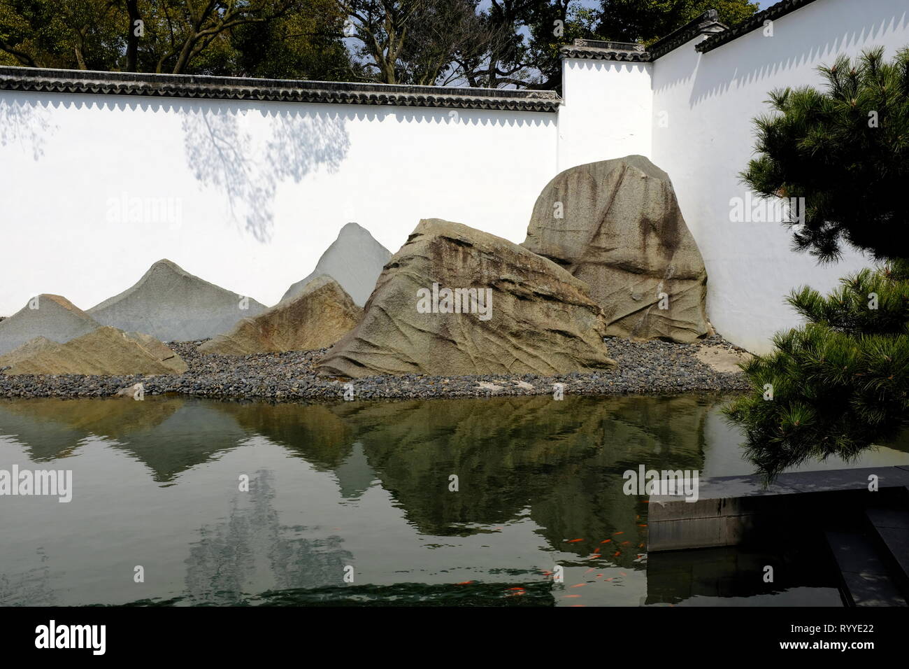 Rockery by the reflecting pool in the garden of Suzhou Museum designed by I.M.Pei. Suzhou.Jiangsu Province.China Stock Photo