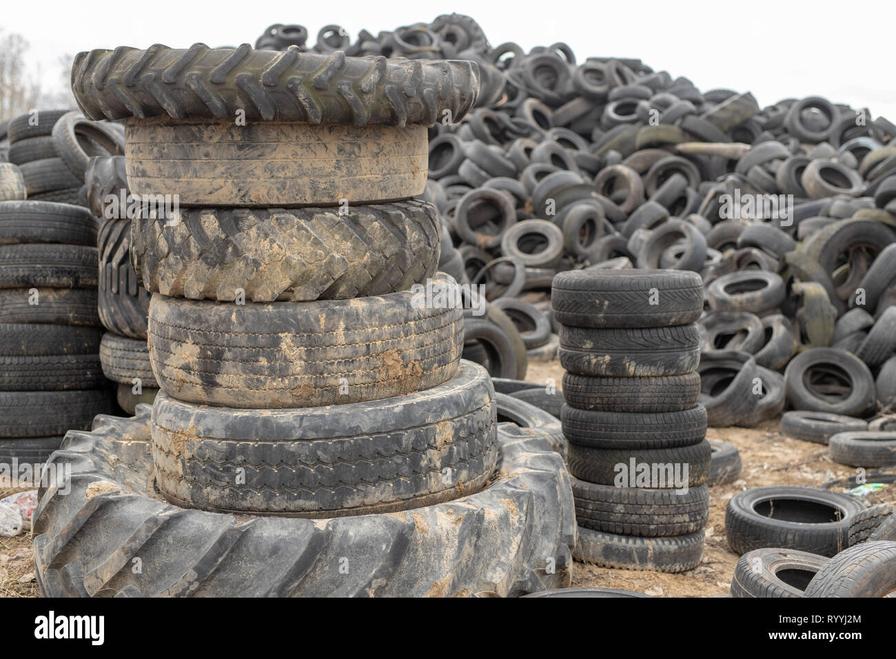 Old worn out tires on an abandoned trash dump. Garbage heap ready for