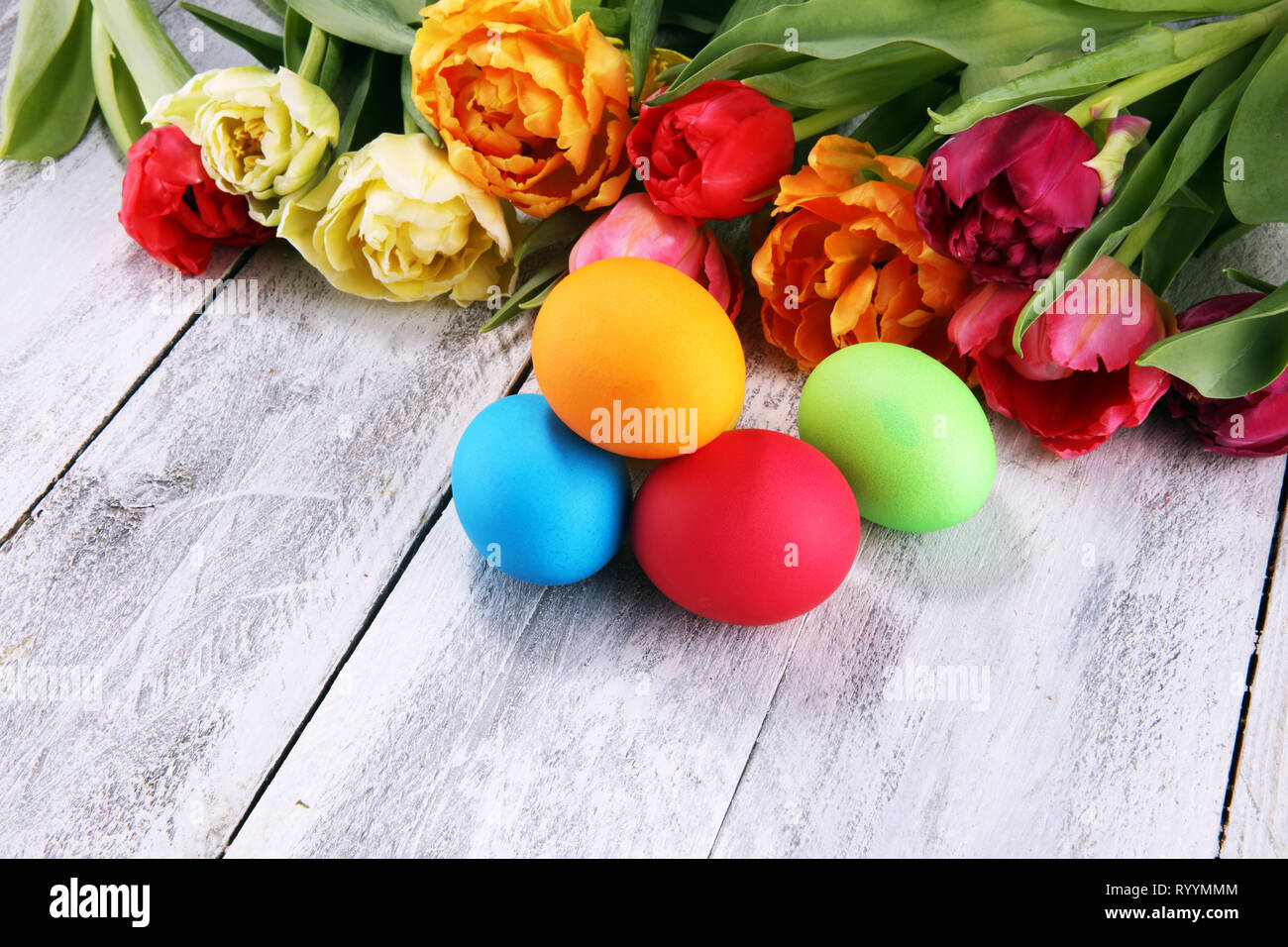 Festive table setting for Easter with colorful eggs and tulip on spring Stock Photo
