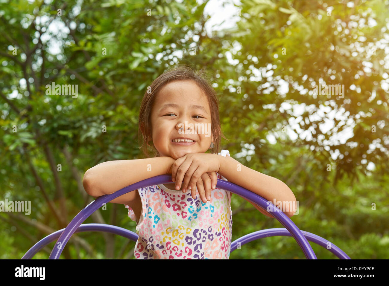 Asian girl smiling in a playground. Filipina kid Stock Photo