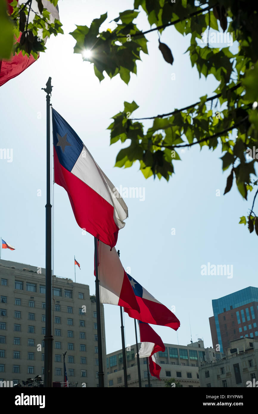 Chilean flags wave in Plaza de la Constitución, or Constitution Square, in downtown Santiago, Chile. Stock Photo