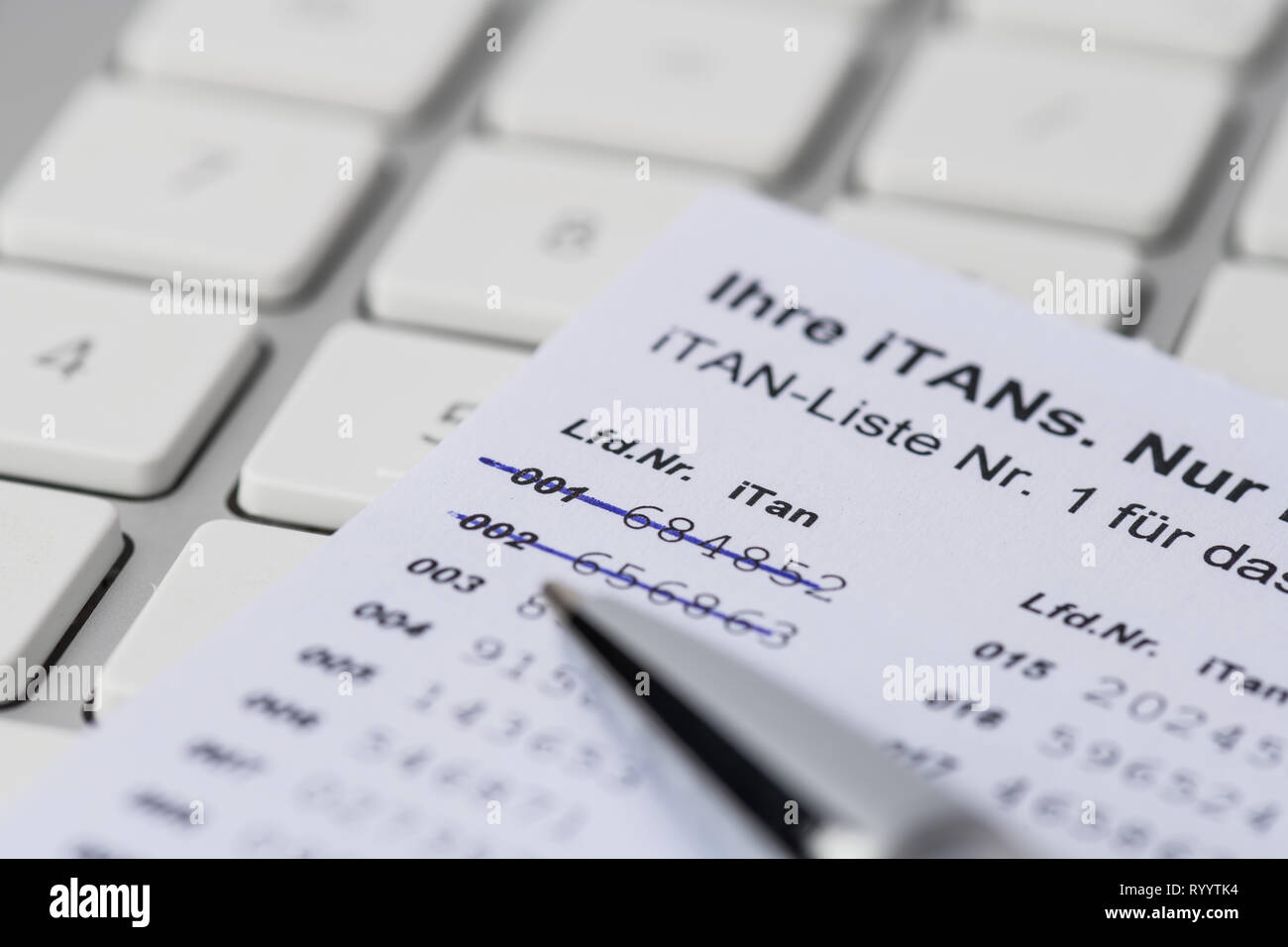 iTan-list with pen and computer keyboard Stock Photo