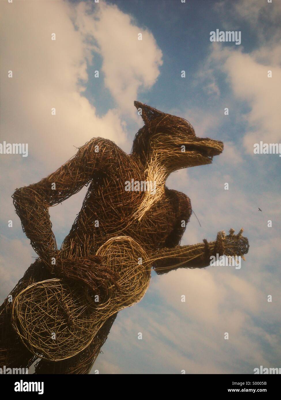 Wicker statue of a fox playing guitar - Smartphone Captured Stock Image