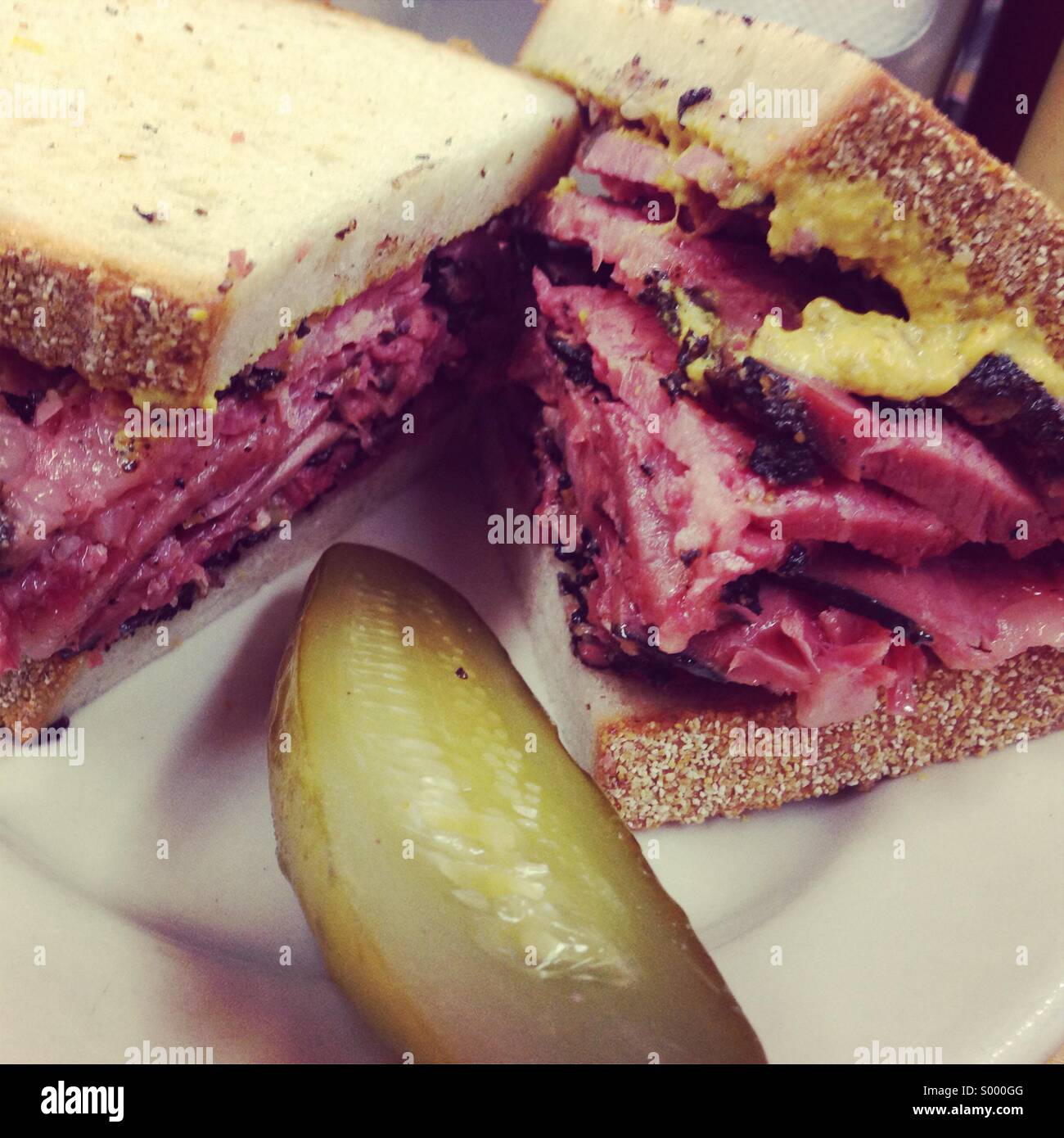 Pastrami and mustard sandwich with pickle, Katz deli, NYC Stock Photo