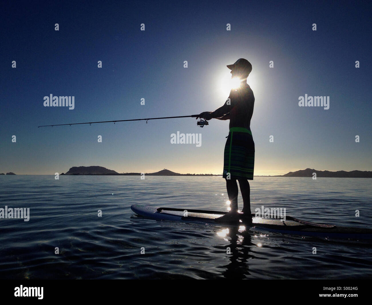 Another day at Kaneohe Bay. Fishing at sunrise. Stand up paddle wake up. Stock Photo