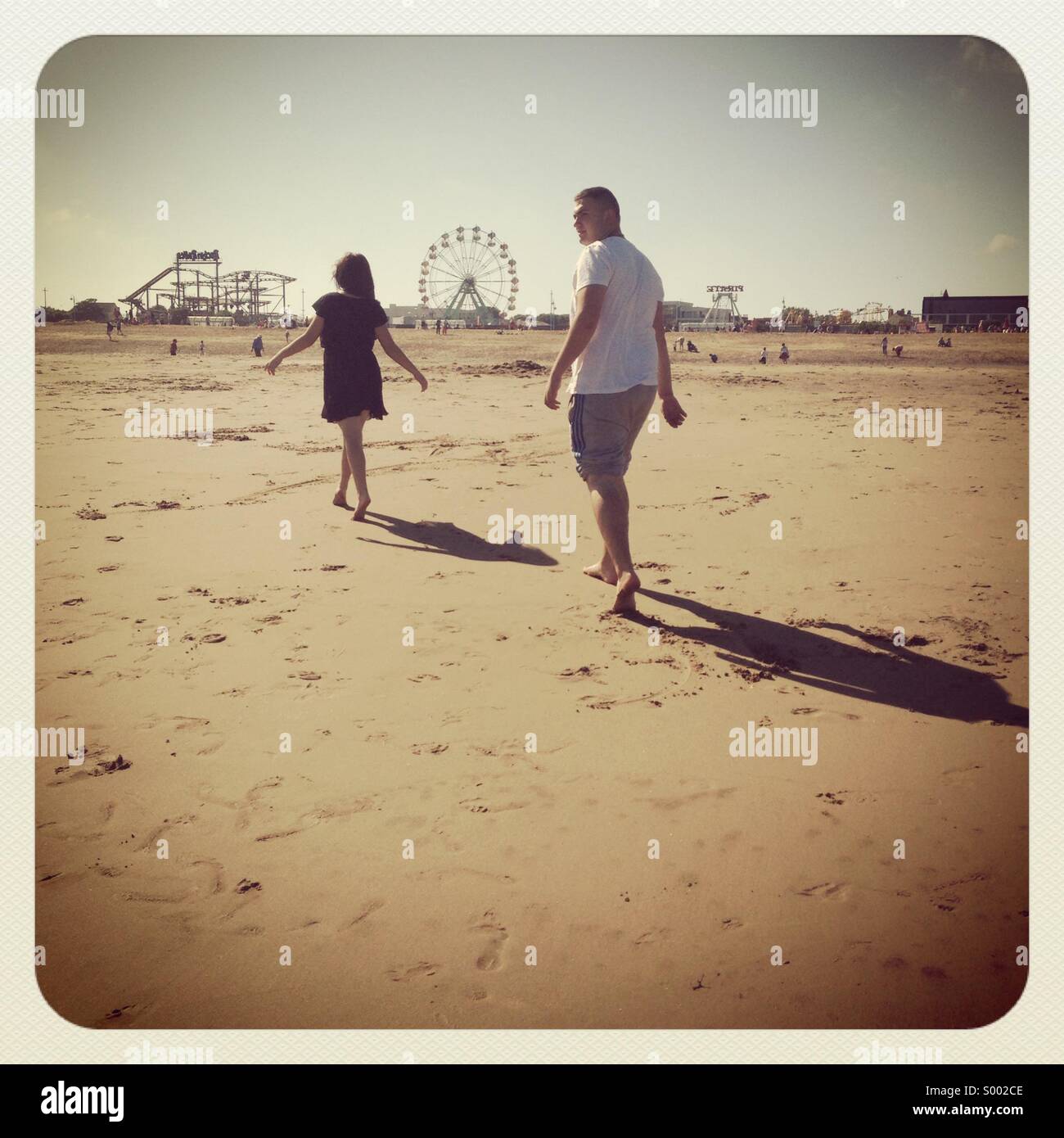 Lovers walking on beach Stock Photo Alamy
