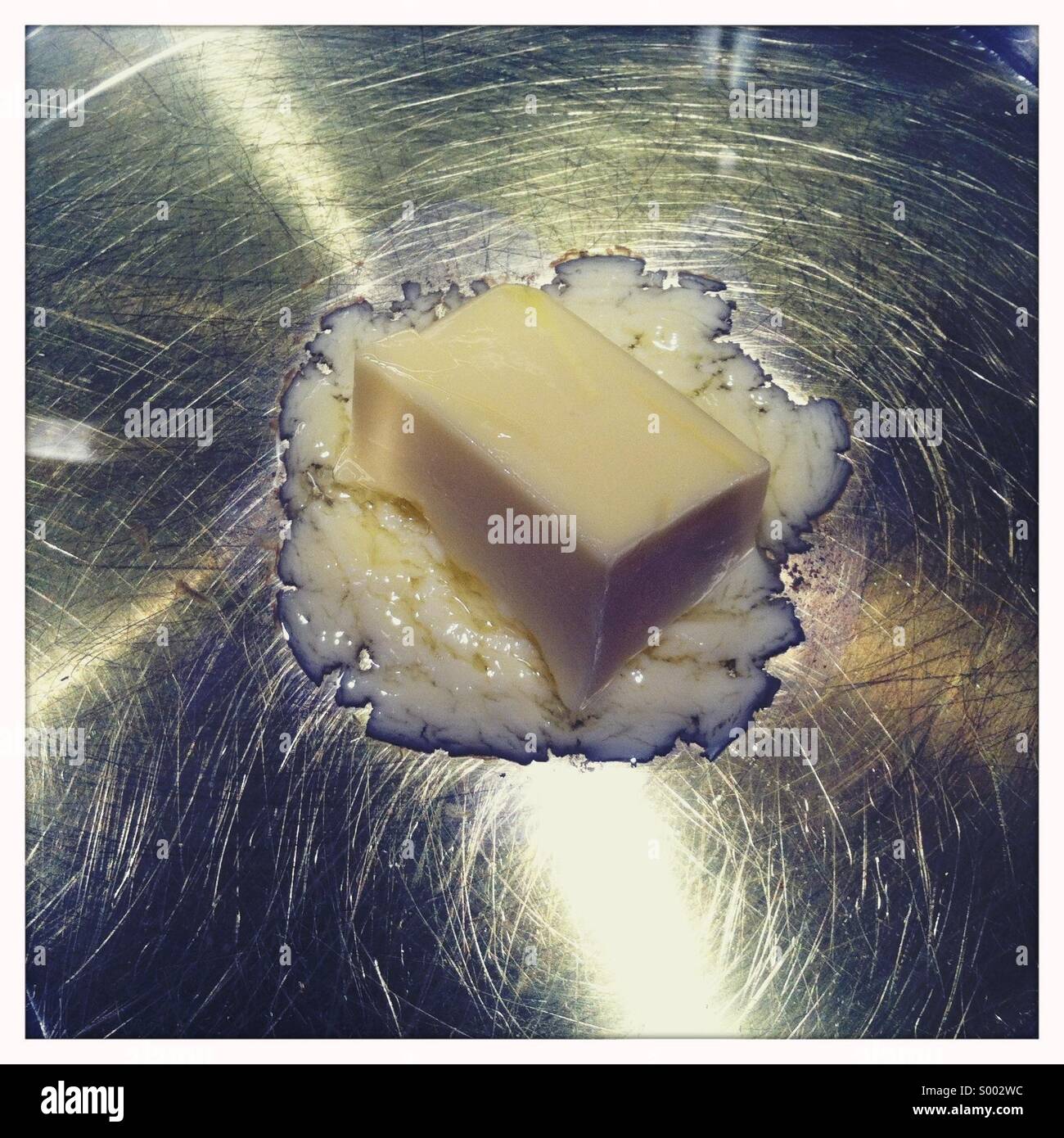 A stick of butter slowly melting in a frying pan Stock Photo Alamy