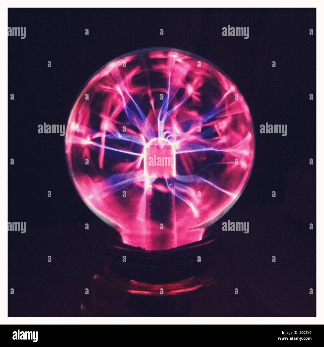A electric glass ball showing glowing energy Stock Photo Alamy
