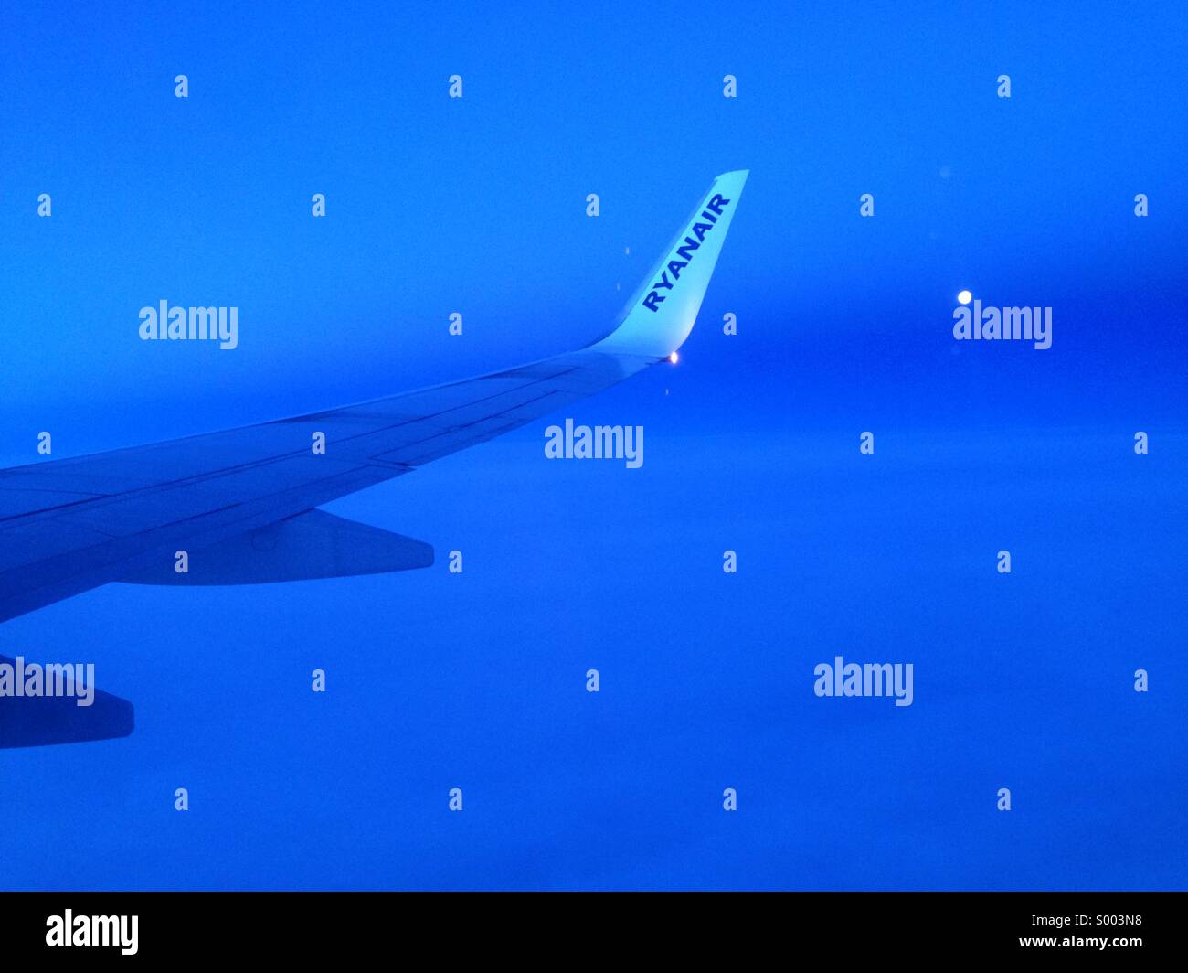 Night times scene looking from aircraft window of a Ryan Air Flight Stock Photo