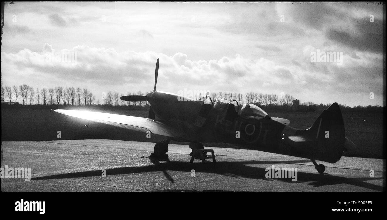 A spitfire sits on the Tarmac in the winter sun - Smartphone Captured Stock Image