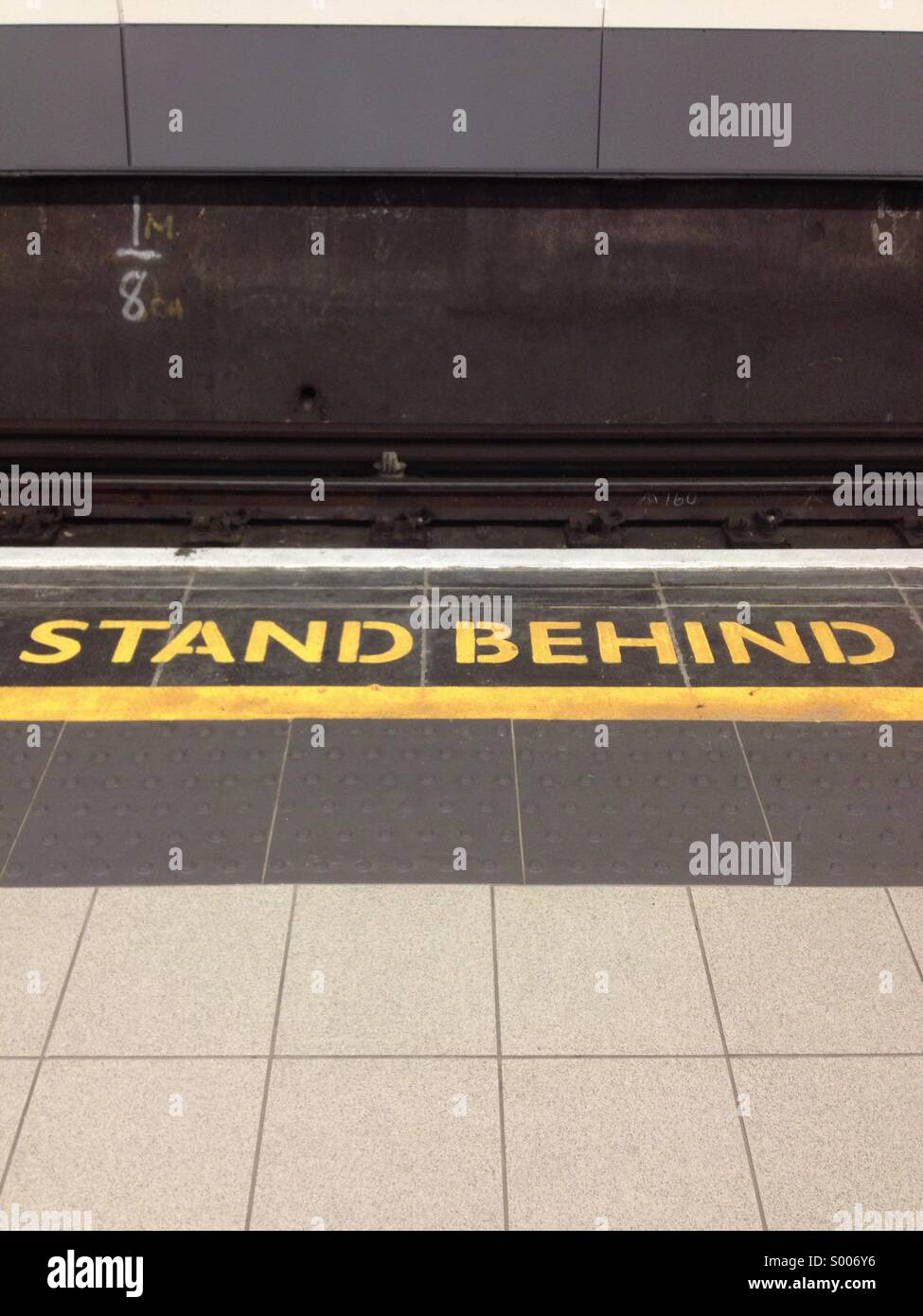 Stand behind warning sign in London Tube, UK Stock Photo