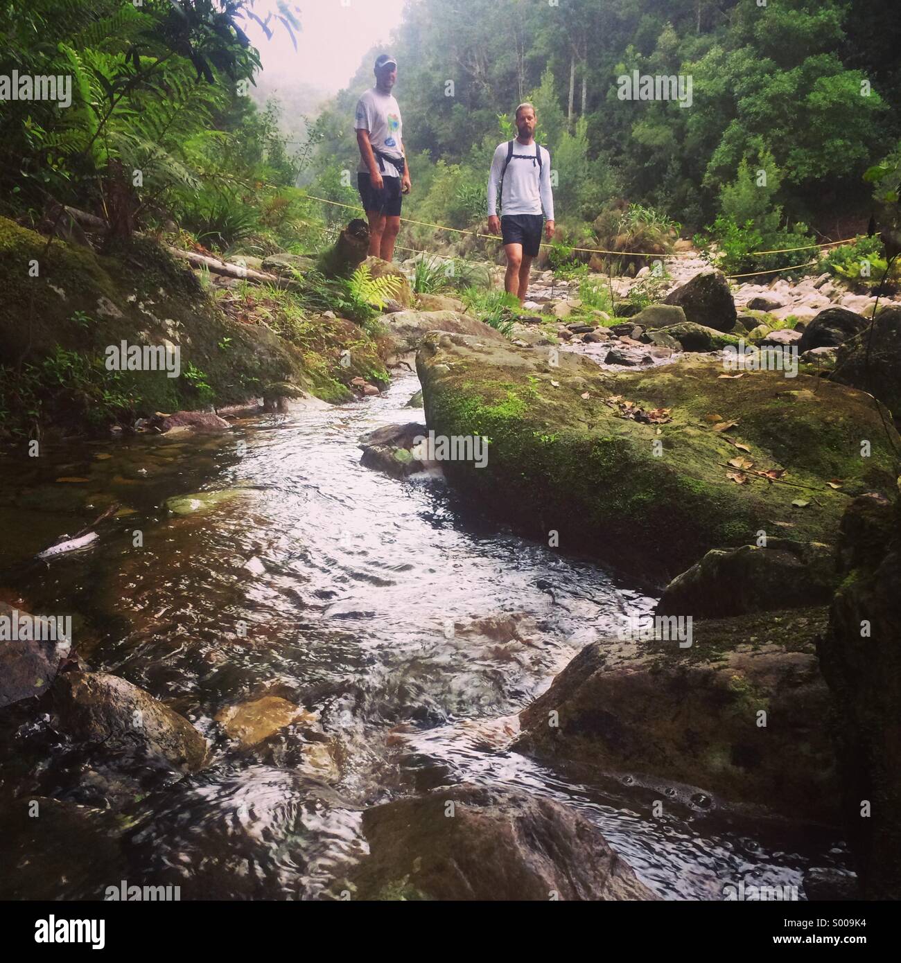 Trail Running river crossing Stock Photo